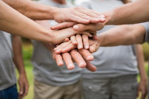 Happy family putting their hands together 