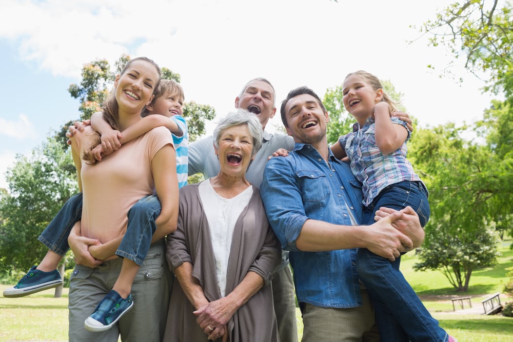 Portrait of cheerful extended family standing at the park-1