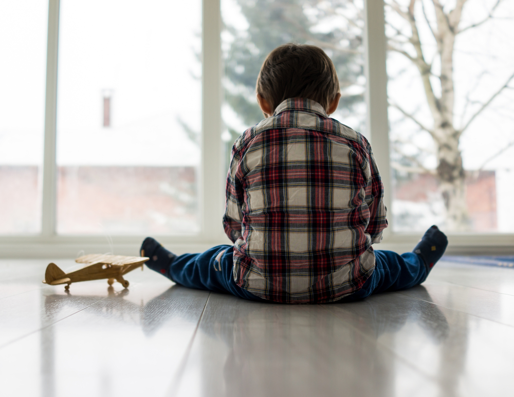 Sad kid sitting on floor